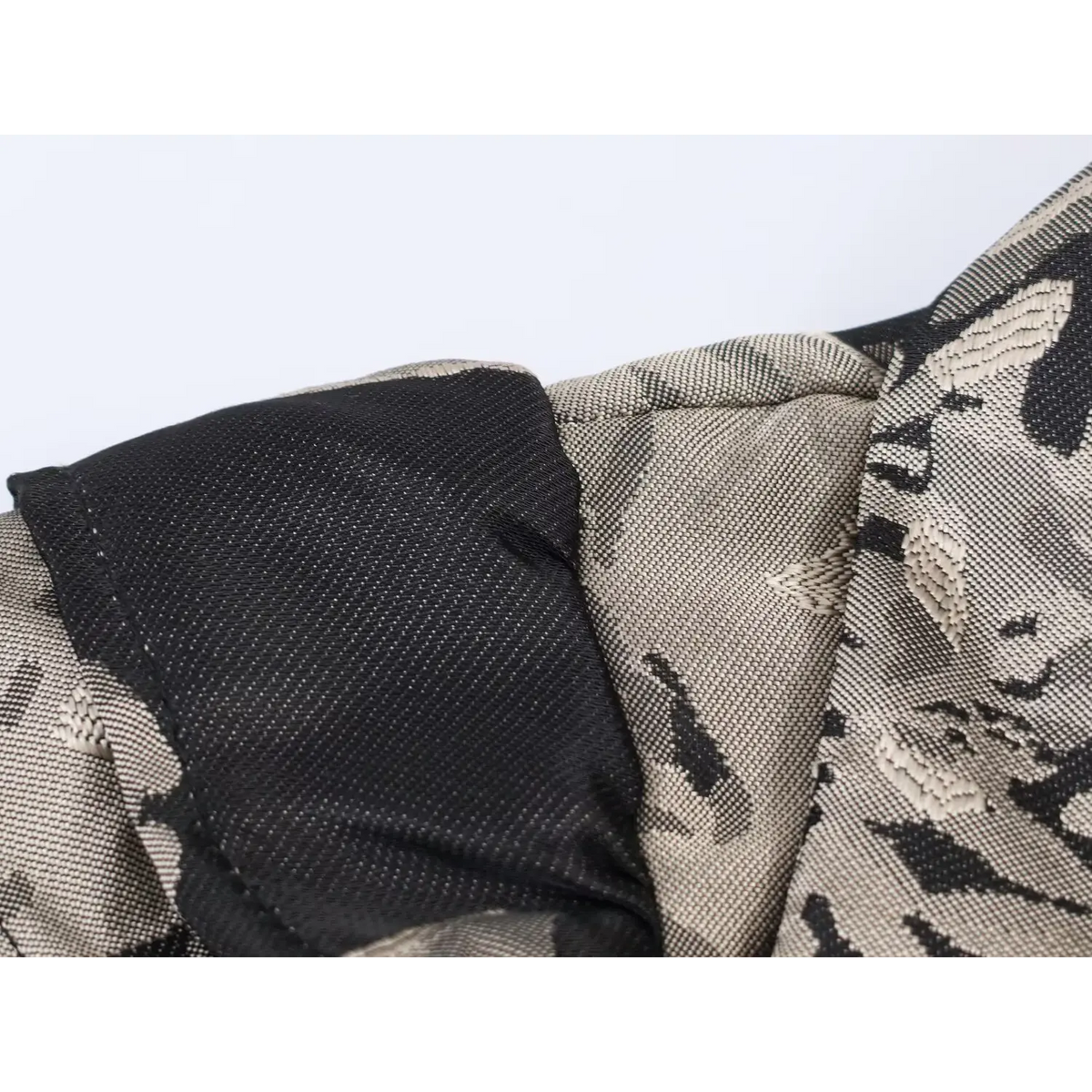 Close-up of inner lining and neat stitching seam of black grey floral jacquard mini dress