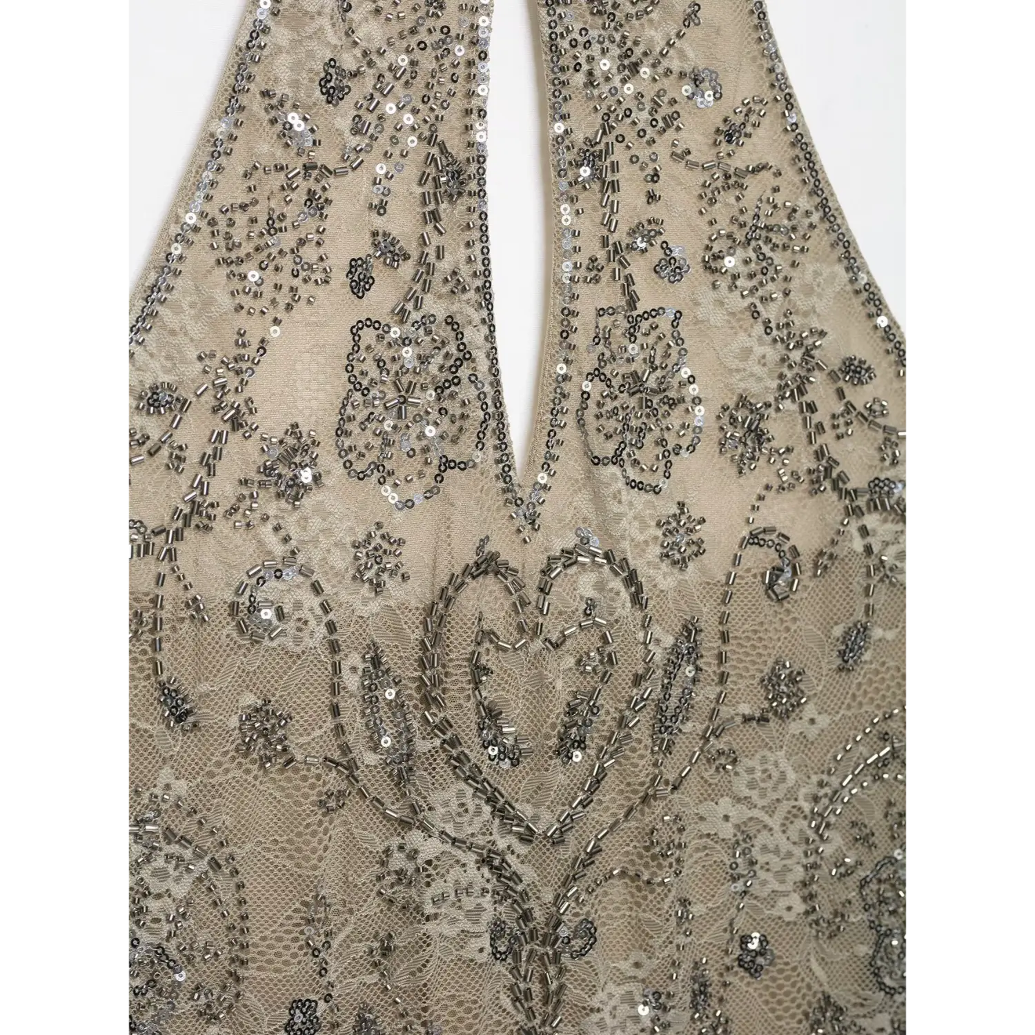 Macro close‑up front keyhole cutout area with dense silver tube bead and sequin floral embroidery on beige lace