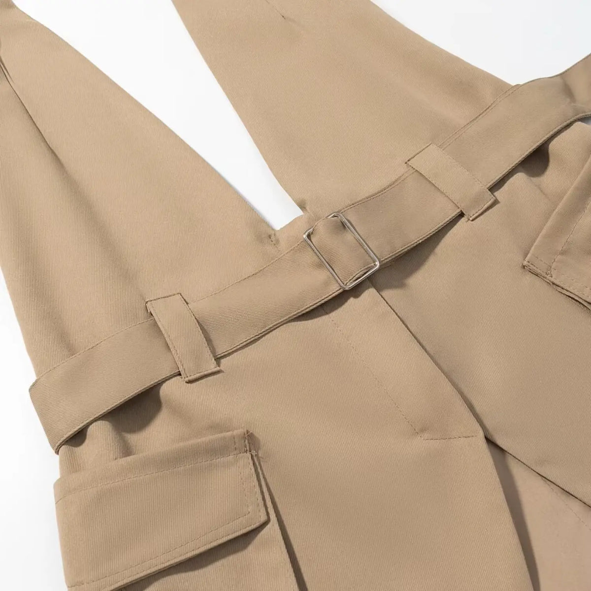 Close-up of khaki belt buckle and flap pocket