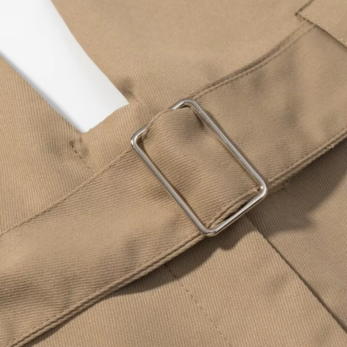 Close-up of silver rectangular belt buckle