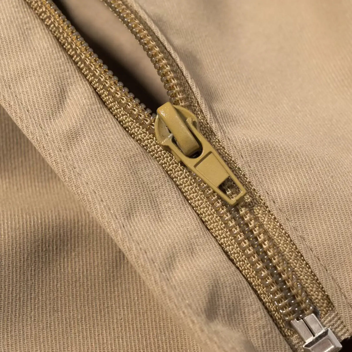 Close-up of khaki back zipper pull