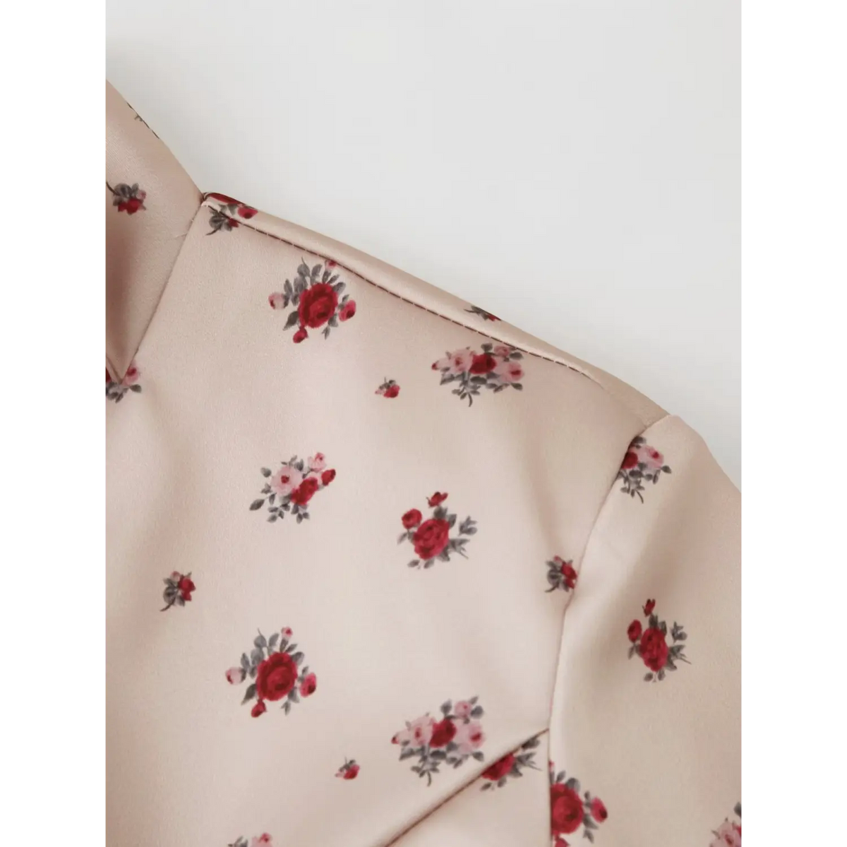 Close‑up fabric texture and ditsy rose floral print on khaki maxi dress