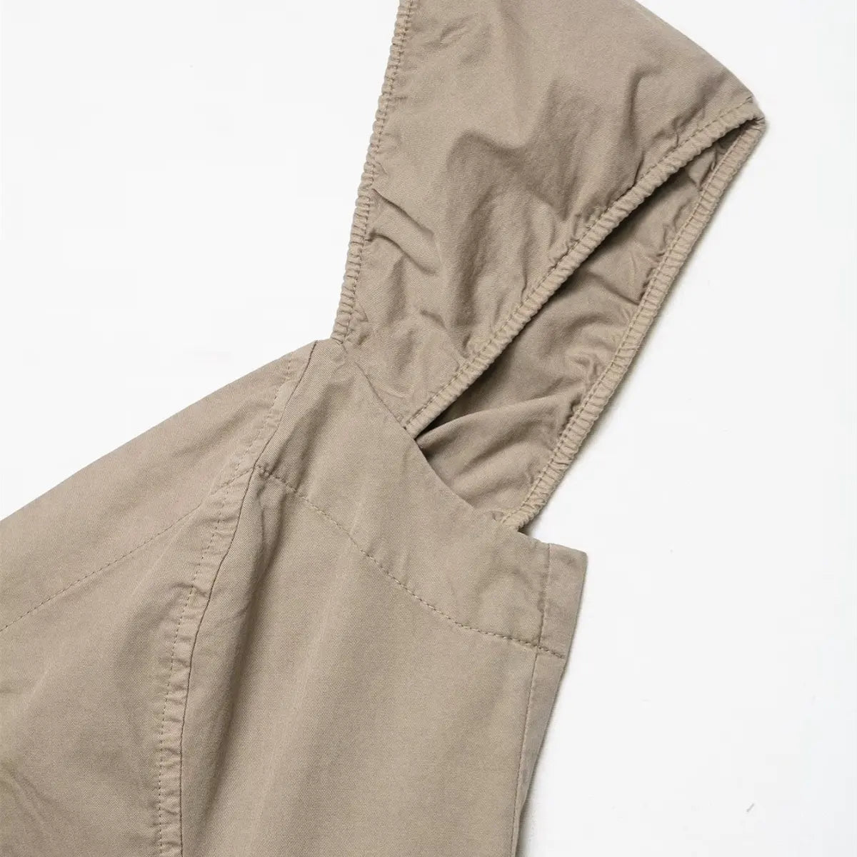 Close-up of the ruched cap sleeve on the khaki dress, showing the elasticated edge and fabric texture
