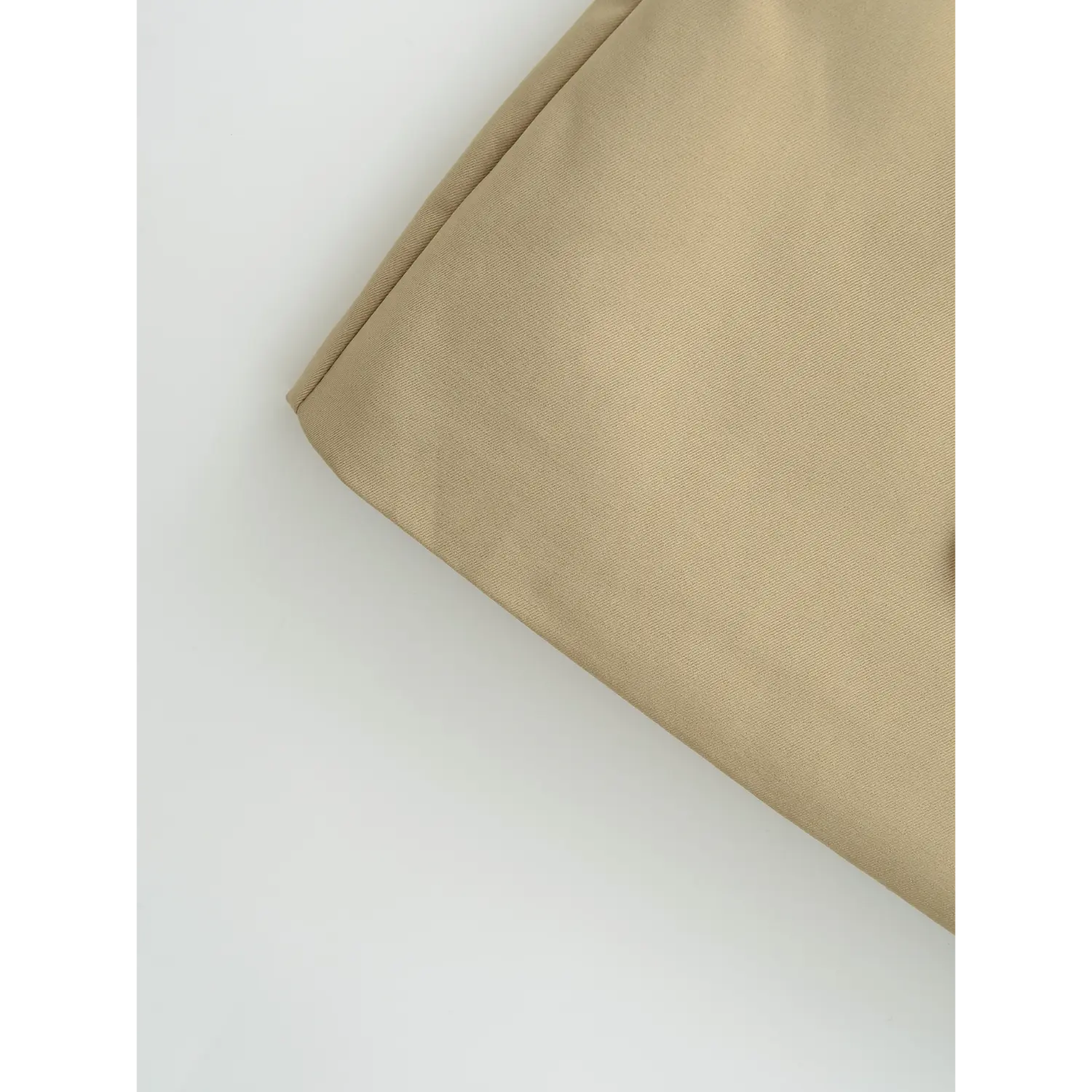 Khaki mini skirt a-line hem flat close-up, flared curved hem double overlock binding stiff wrinkle-resistant twill fabric white background shot