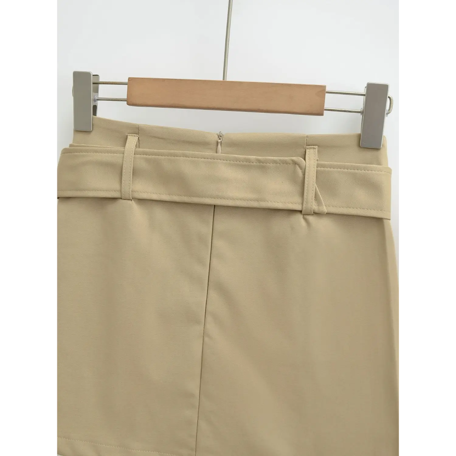 Khaki workwear mini skirt full back waist flat close-up, center invisible zipper one-piece unsegmented back waist dual belt loops even stitching waistband white background shot