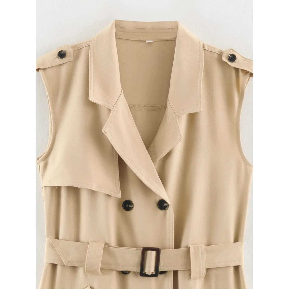 Close-up of notched lapel, double breasted buttons and belt