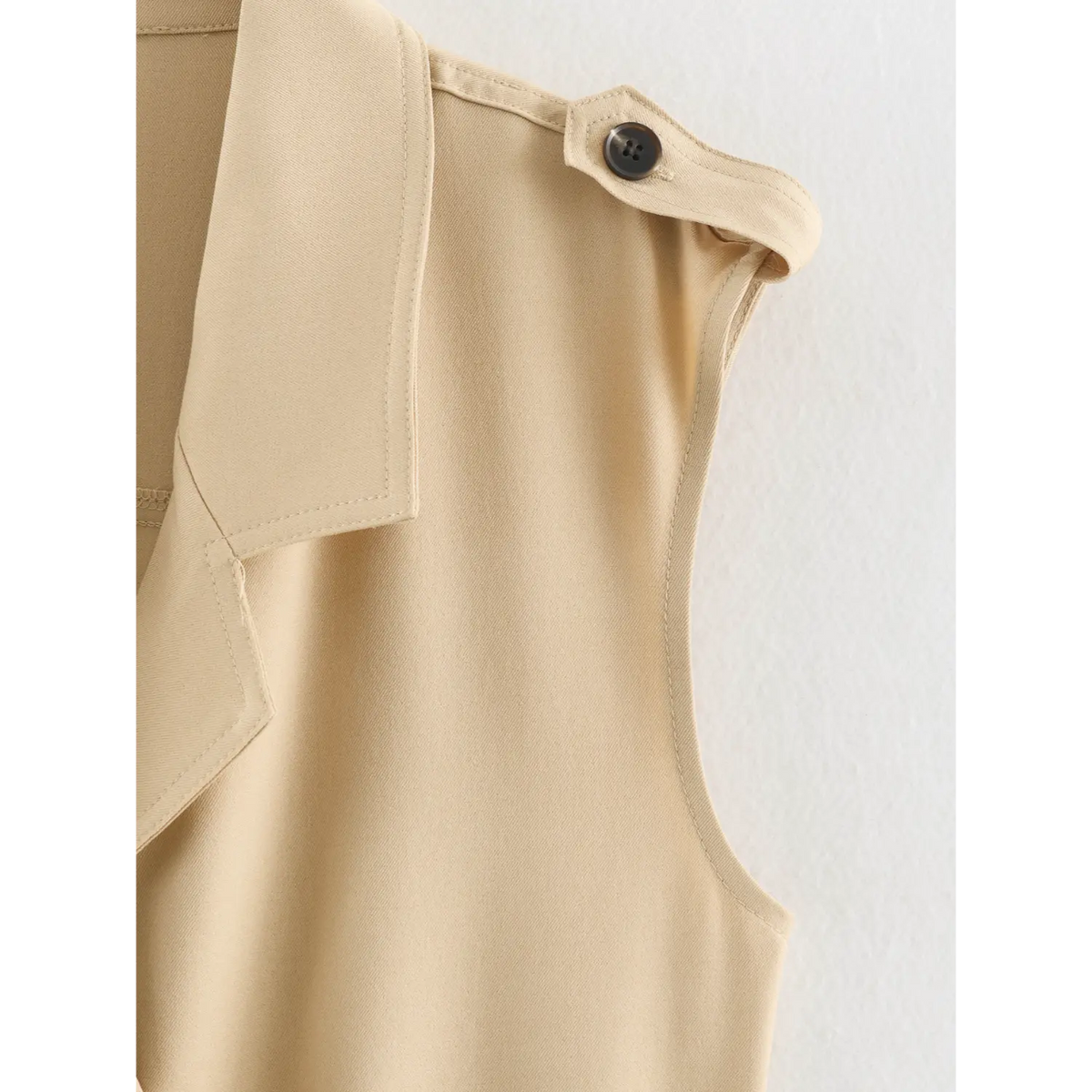 Close-up of epaulette button and armhole