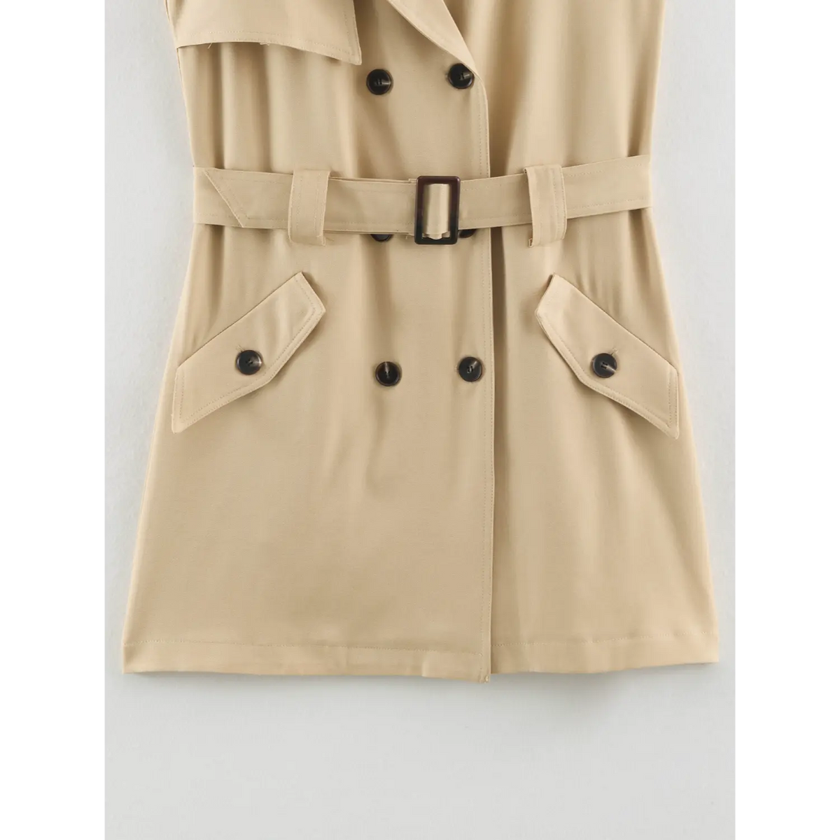 Close-up of double breasted buttons, flap pockets and belt
