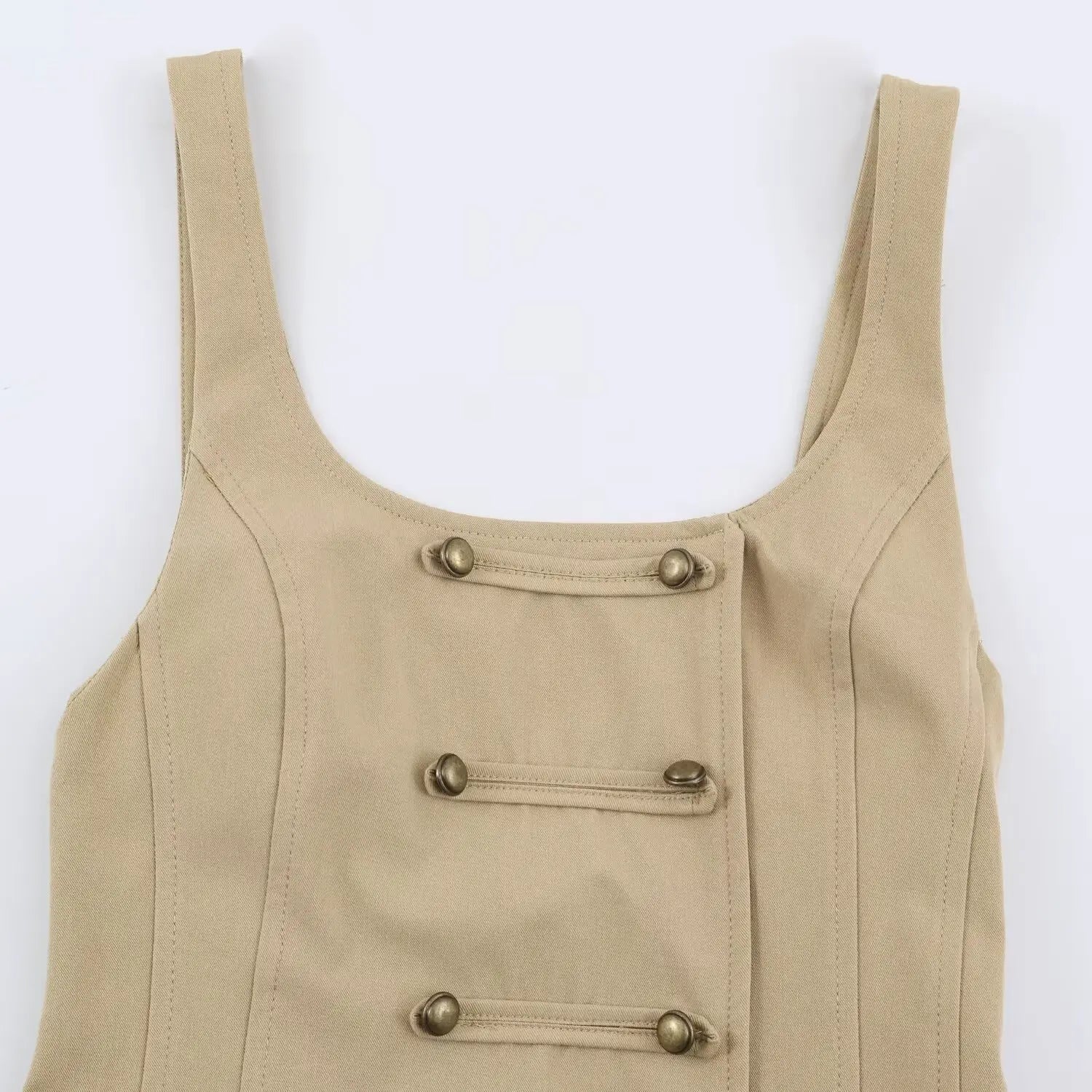 Close up of square scoop neck and vertical double brass button placket on khaki twill cami dress