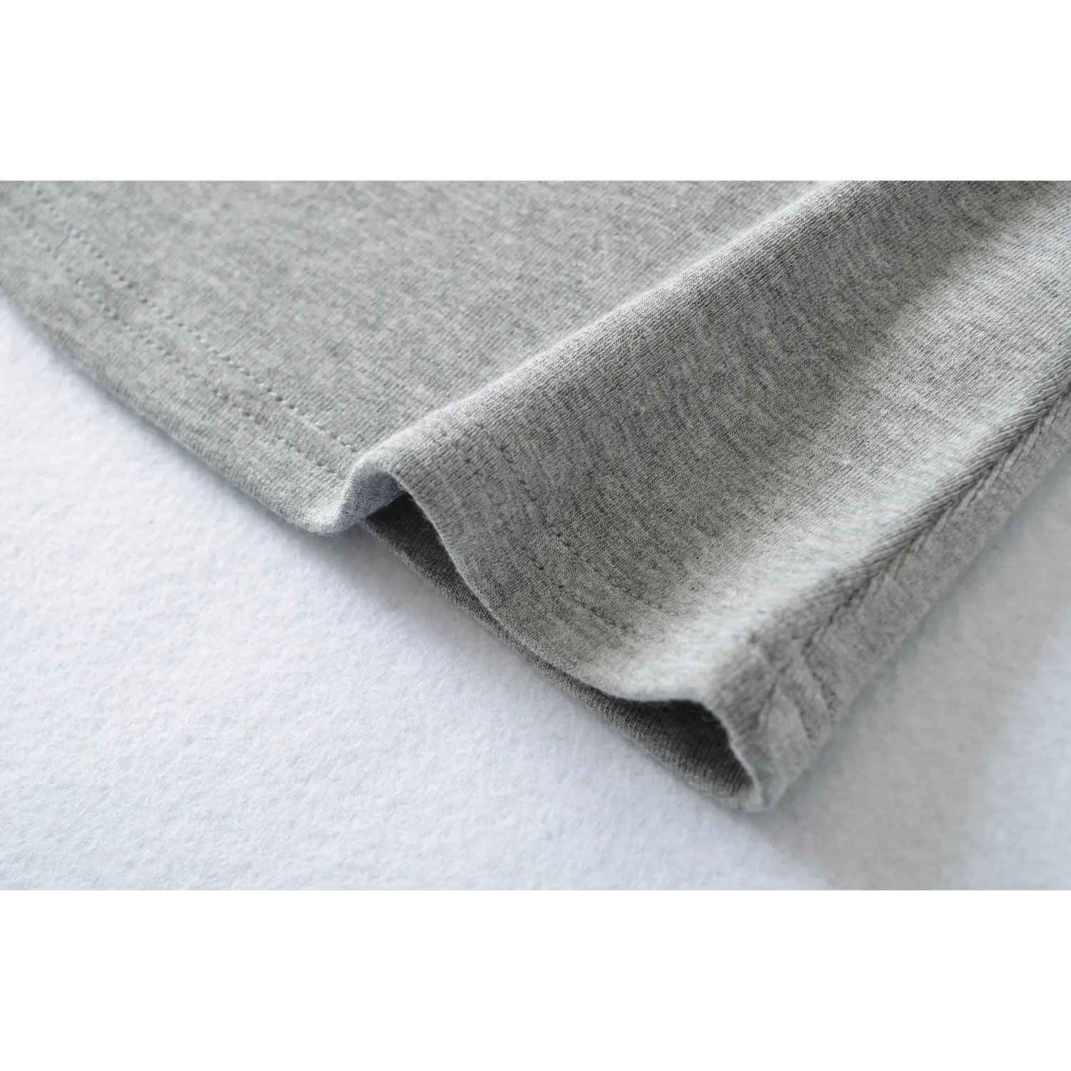 Knit cami bottom rib binding hem macro close-up, double neat stitching anti-curl durable hem sewing craft shot