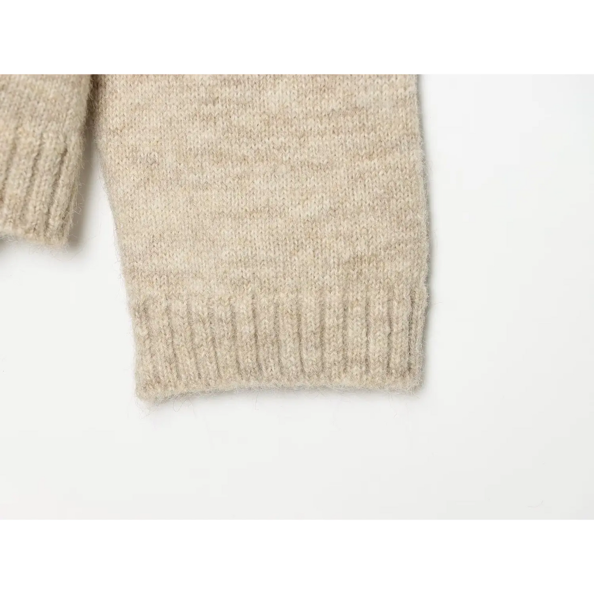 Close-up of ribbed sleeve cuff on oatmeal fuzzy knit cardigan