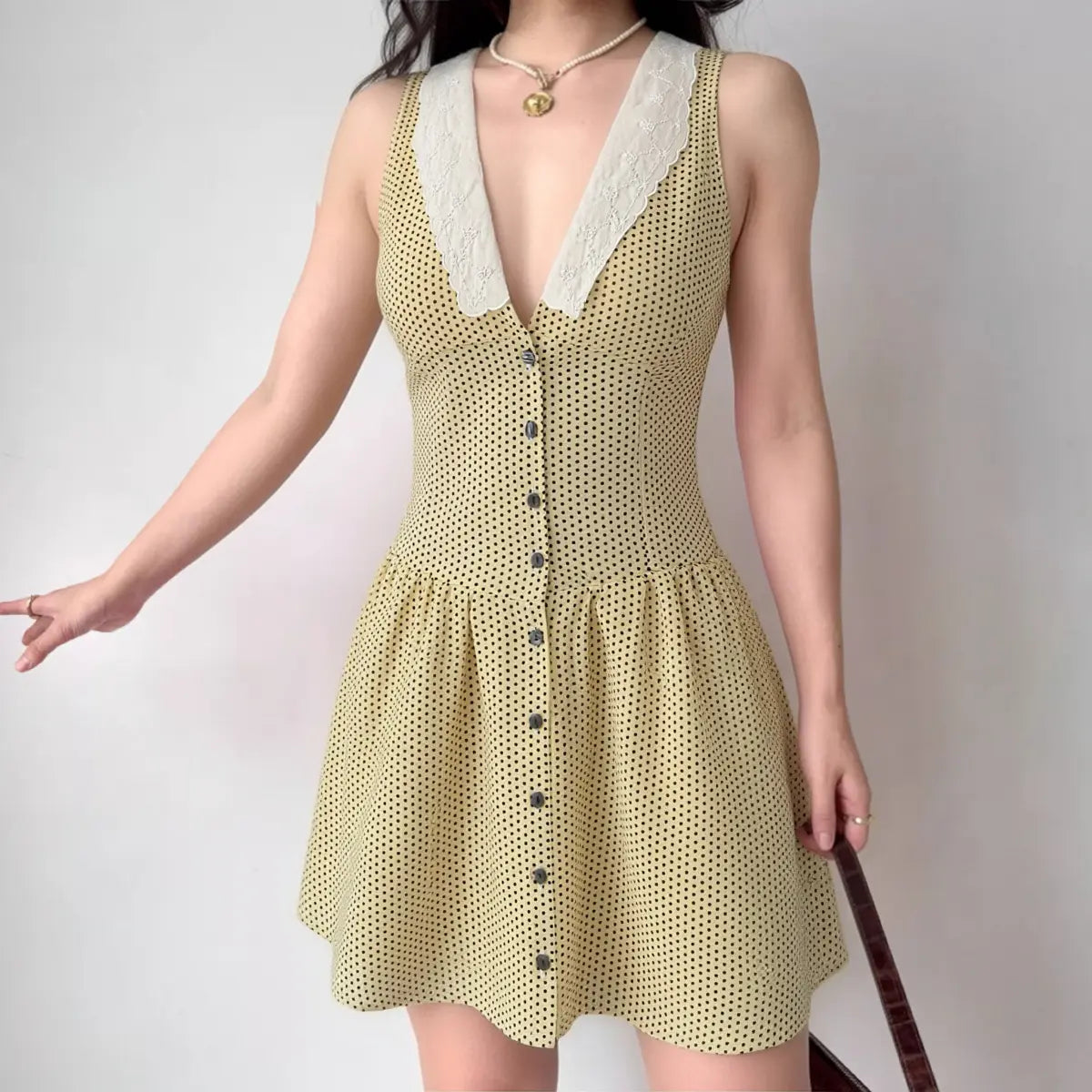 Lifestyle shot V neck lace trim front button yellow dot casual dress