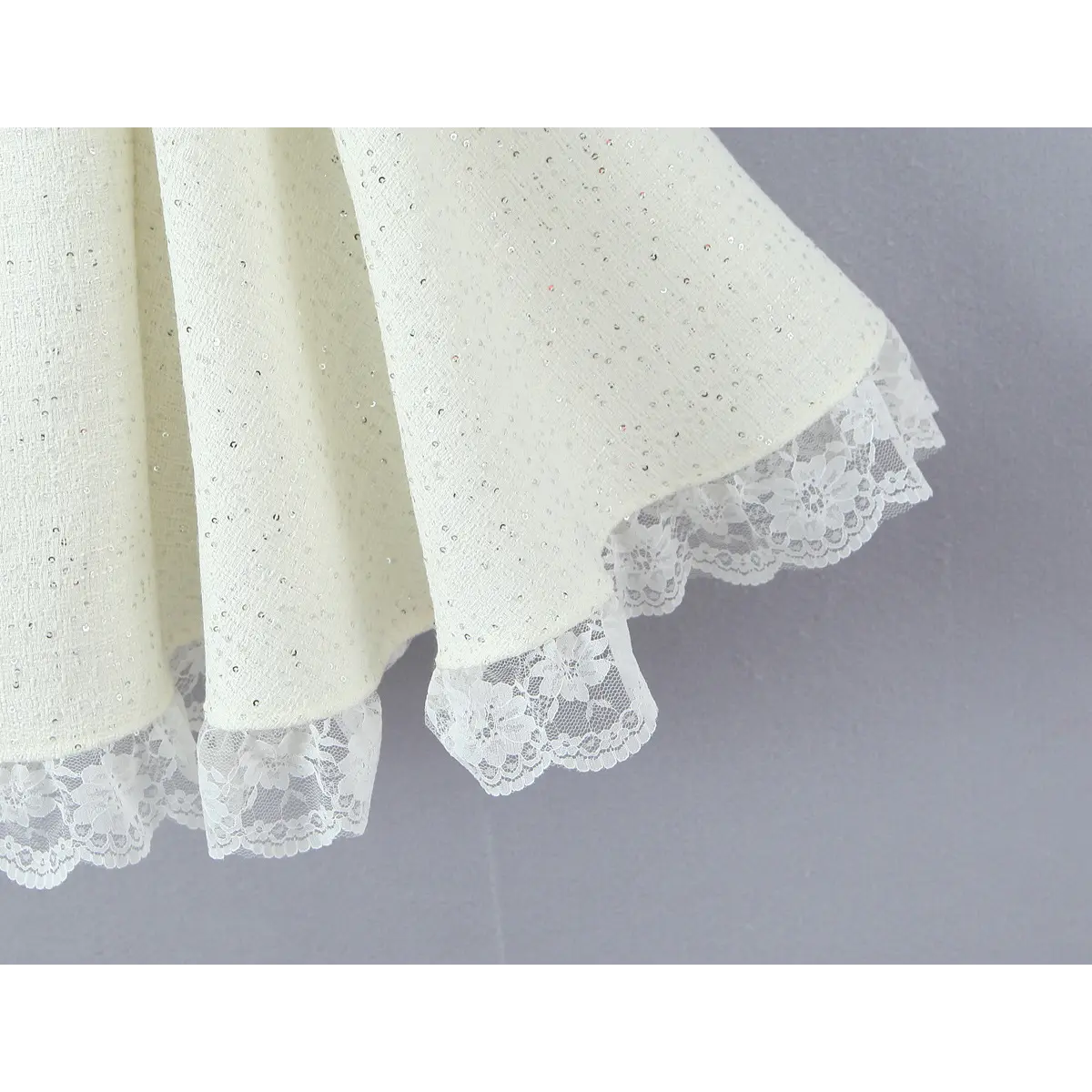 Skirt hem detail, outer tweed + underneath floral lace frill trim, neat finished stitching.