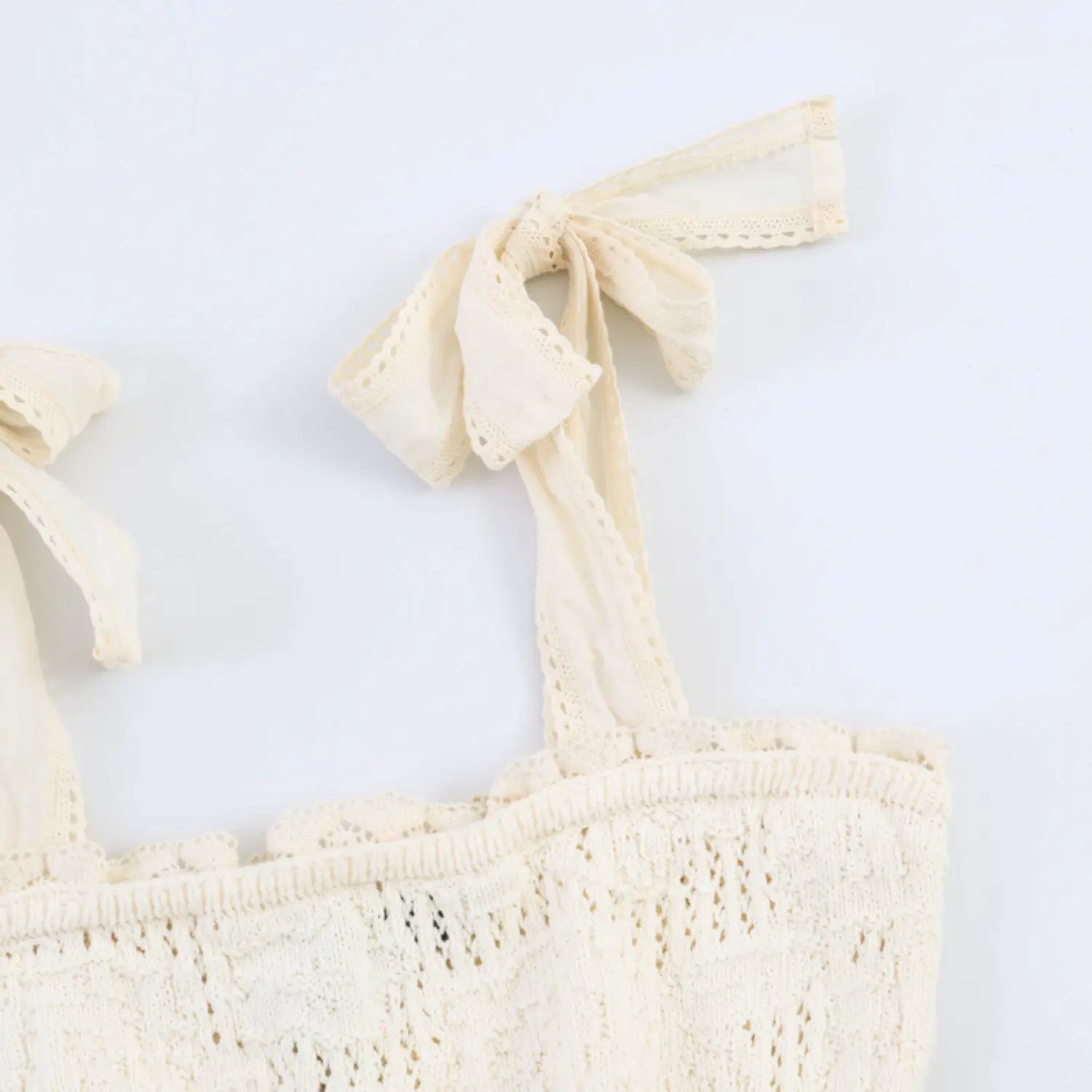 Macro shot eyelet lace edged bow, lightweight woven fabric strap