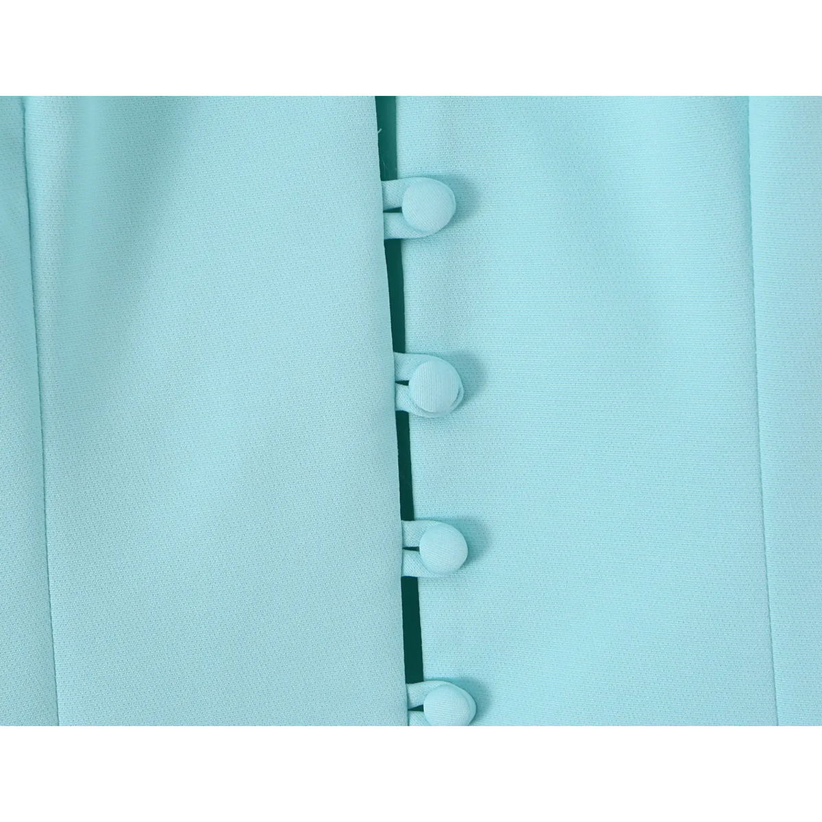 Close-up of same-tone covered buttons on front placket