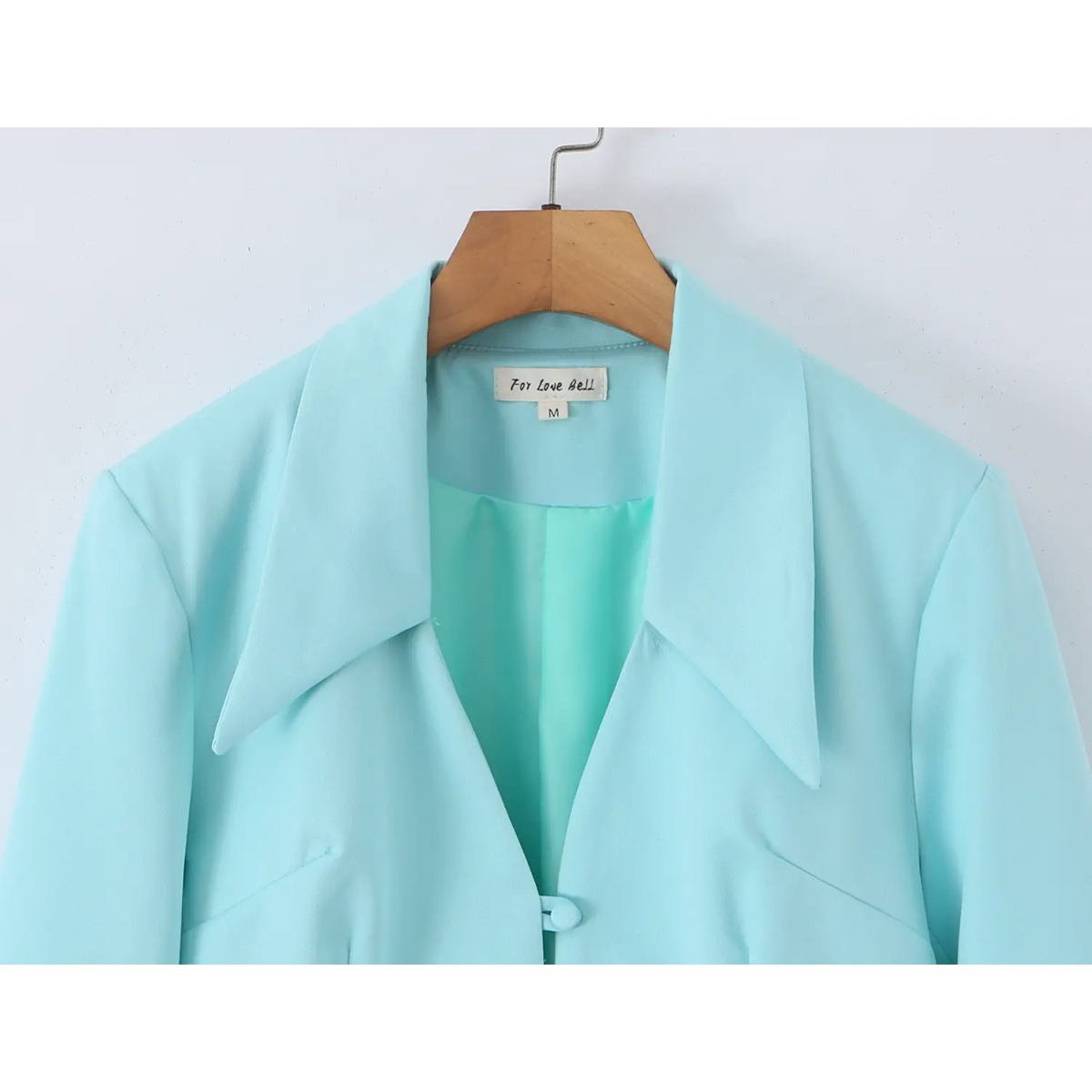 Close-up of pointed collar, neck label and lining
