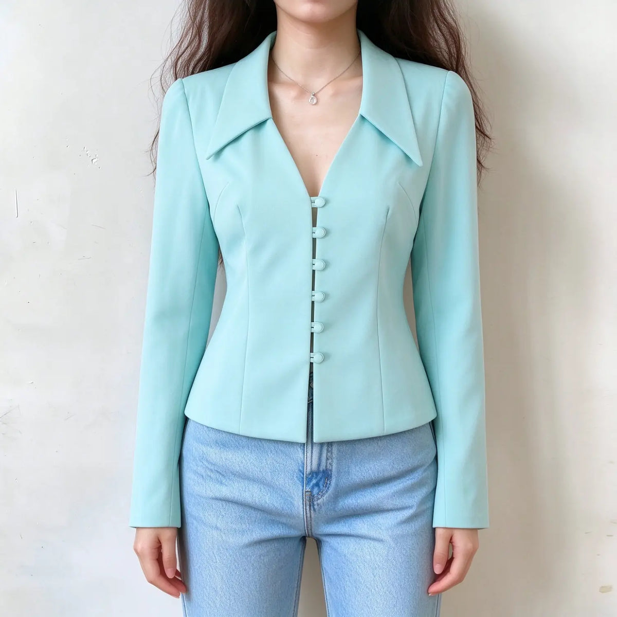 Model wearing lake blue pointed collar button front cropped jacket with jeans, front view