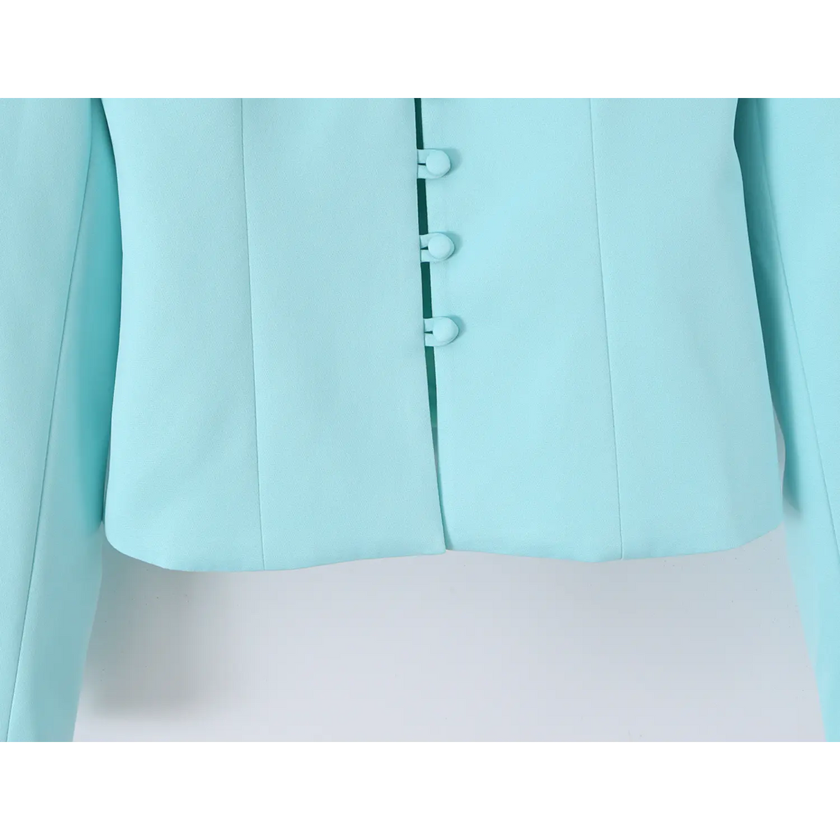 Close-up of front button placket and cropped hem