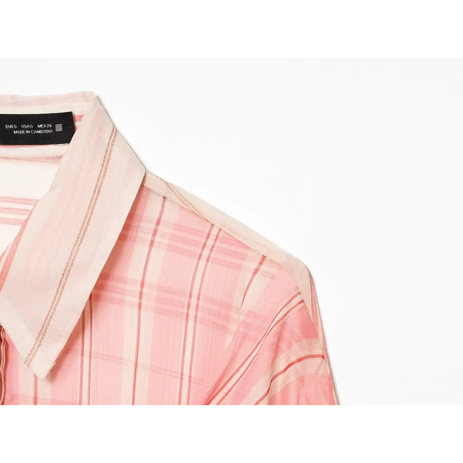 Shoulder collar close-up, pink plaid stripe fabric, zig-zag seam stitching, inner brand label detail
