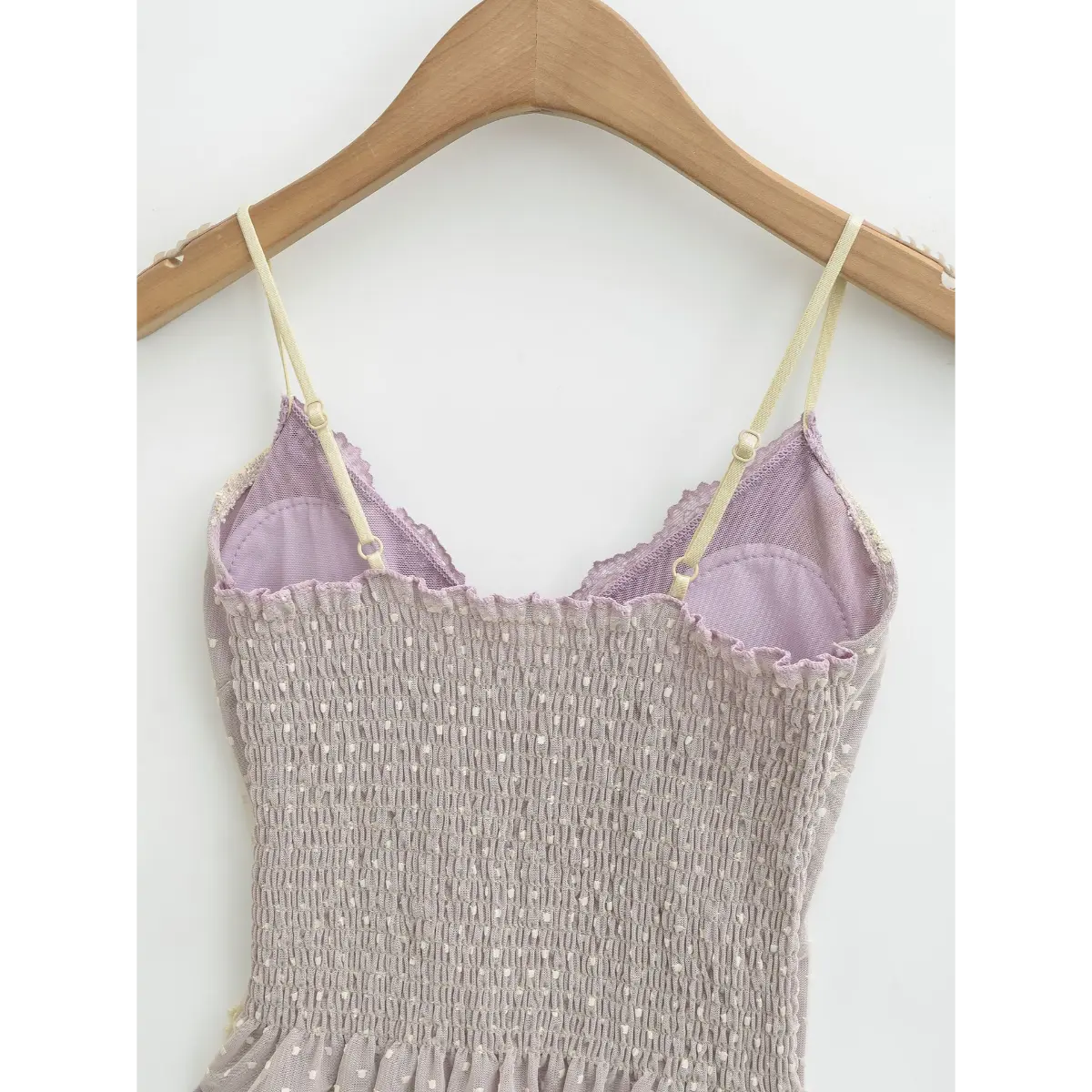 Back view of a lavender heart-mesh camisole, showing the smocked panel and adjustable straps.
