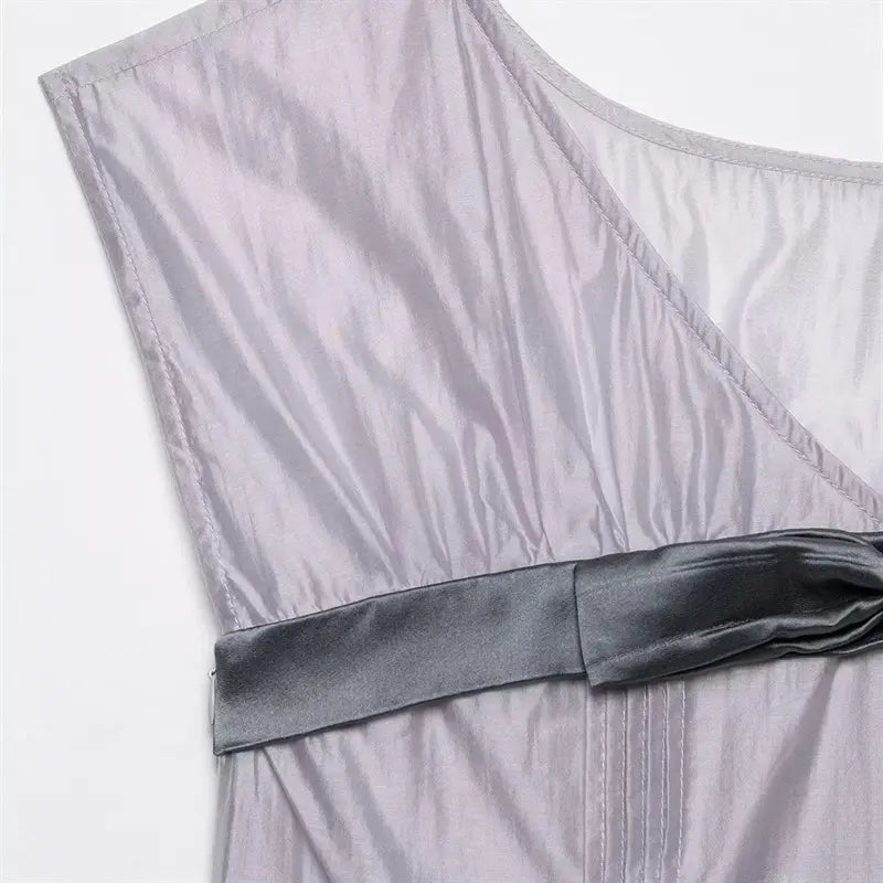 Side waist satin bow and invisible side zipper closeup, diagonal shoulder seam, neat folded edge stitching of cap sleeve