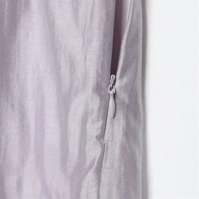 Side invisible hidden zipper closeup, matching fabric teardrop pull tab, convenient side closure for easy dressing