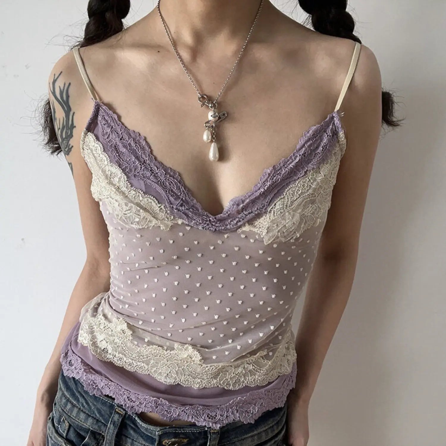 Lavender double contrast lace polka dot mesh cami top half body shot, slim cropped waist v-neck lace edge, matched with layered metal necklaces soft feminine outfit