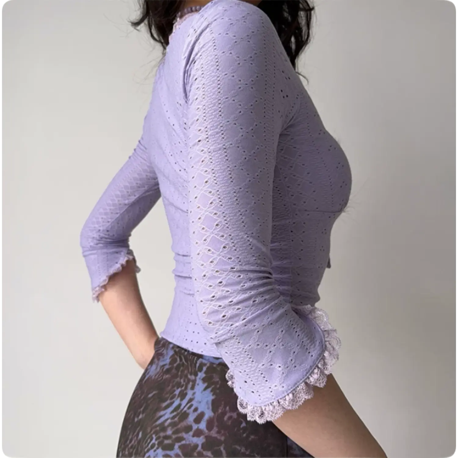 Model back side view lavender eyelet lace cropped top fitted silhouette lace ruffle three quarter sleeve cuffs