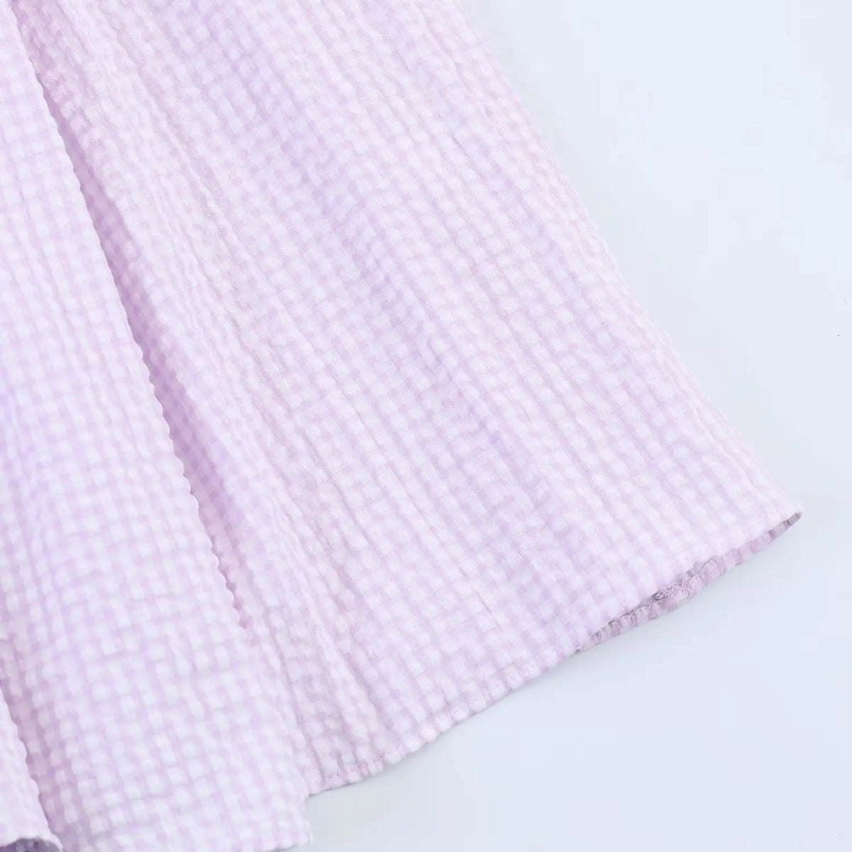 Close-up of maxi dress hem, lavender gingham print, soft crinkle fabric and finished edge