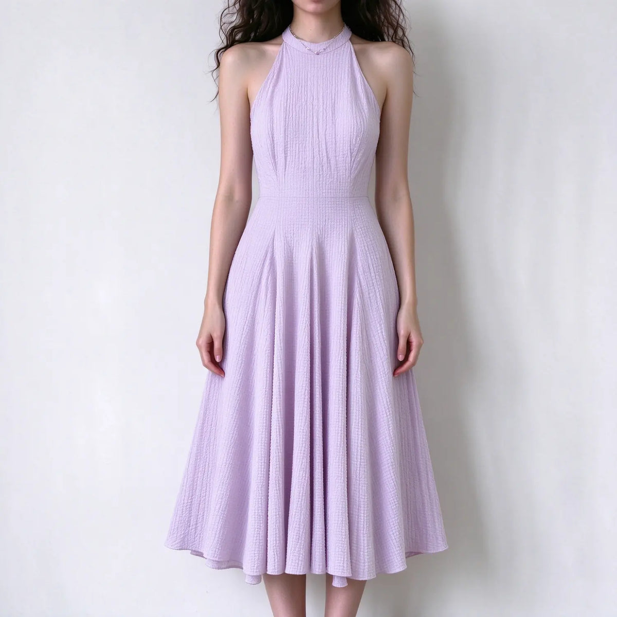 Female model front view wearing lavender textured halter maxi dress, sleeveless, fitted bodice, flared full long skirt