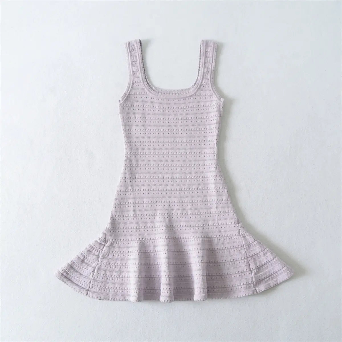 Flat lay view of a lavender knit mini dress, showing the full silhouette with square neckline, fitted bodice, and flared skirt.