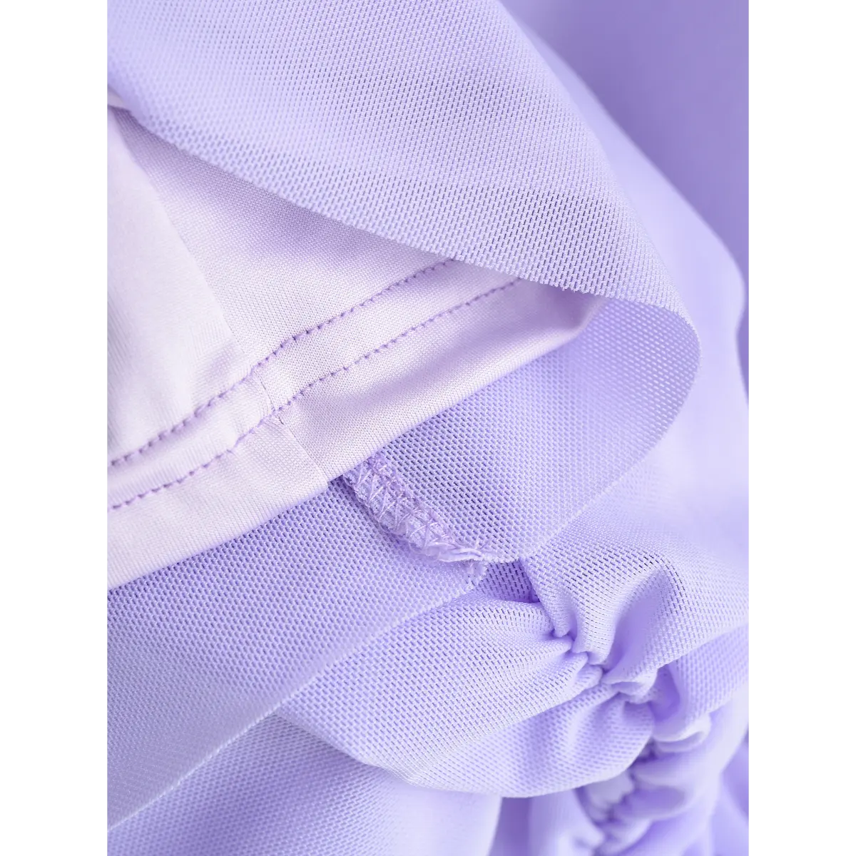 Close-up of the mesh overlay and solid lining on the lavender dress, showing double layer construction