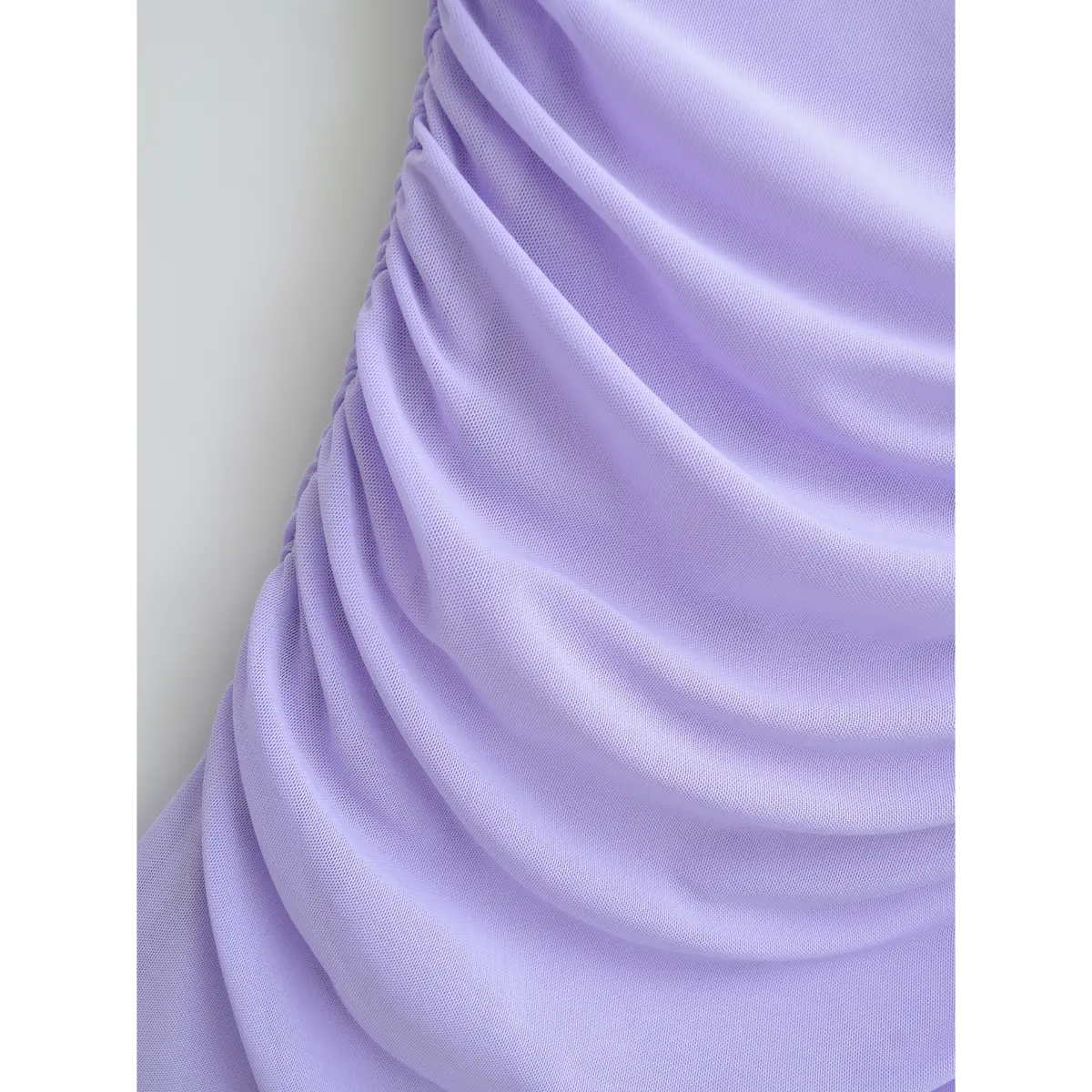 Close-up of the side ruching on the lavender mesh dress, showing draped effect