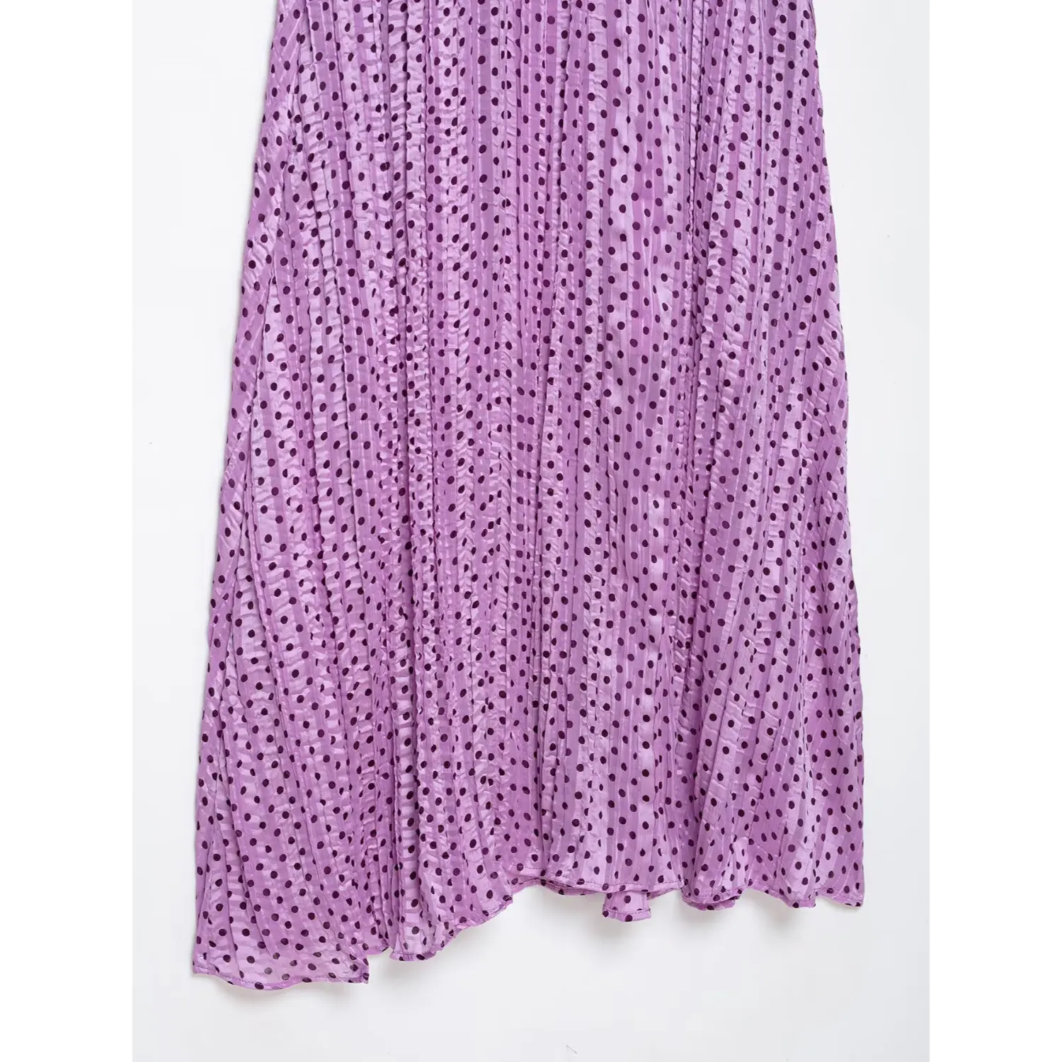 Close-up shot of the all-over vertical crinkle pleated chiffon skirt, showing soft flowy hem and polka dot texture
