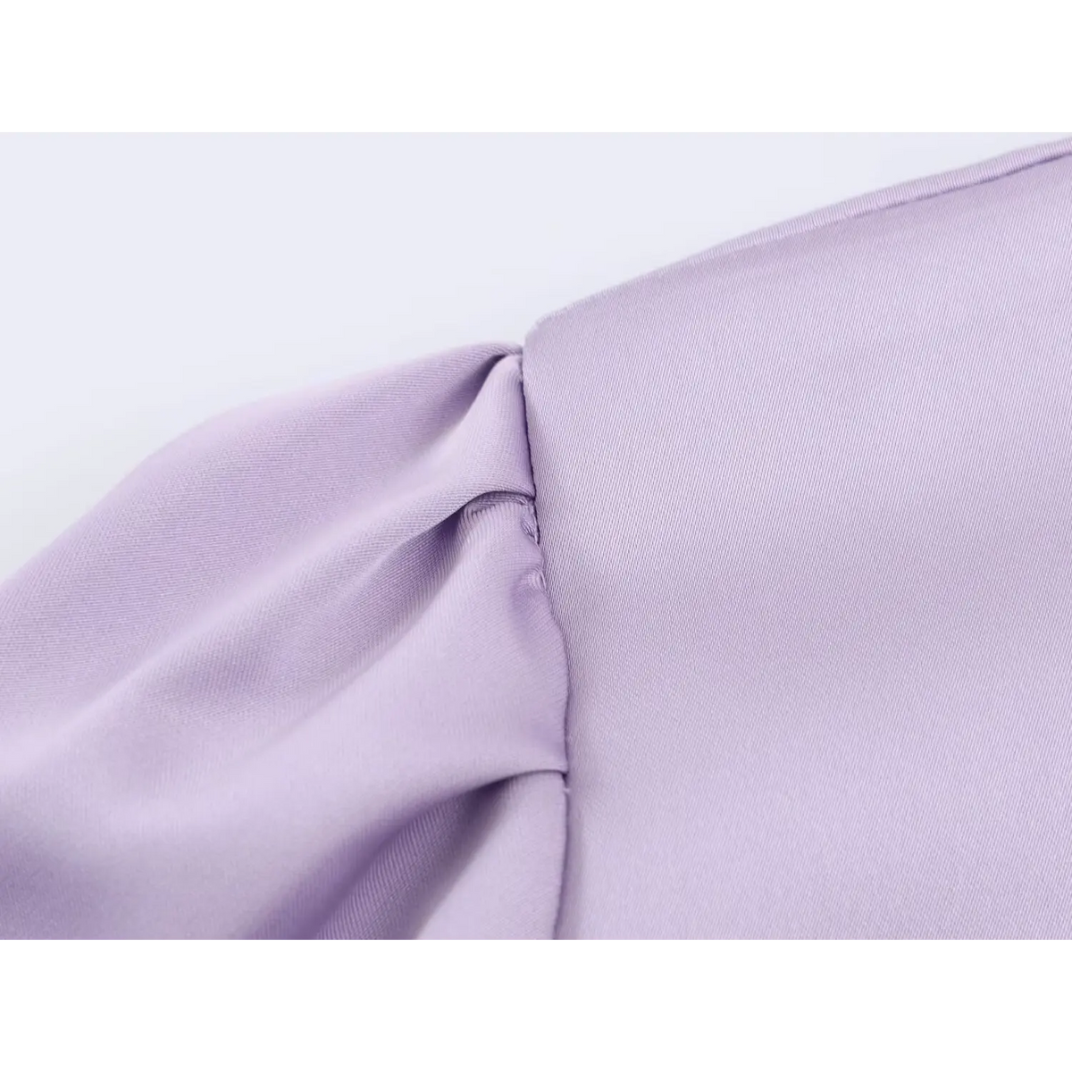 Close-up of armhole seam and shoulder pleat