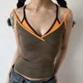 Lifestyle shot of model wearing the layered brown and orange V-neck camisole top