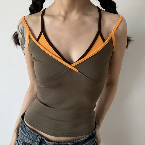 Lifestyle shot of model wearing the layered brown and orange V-neck camisole top