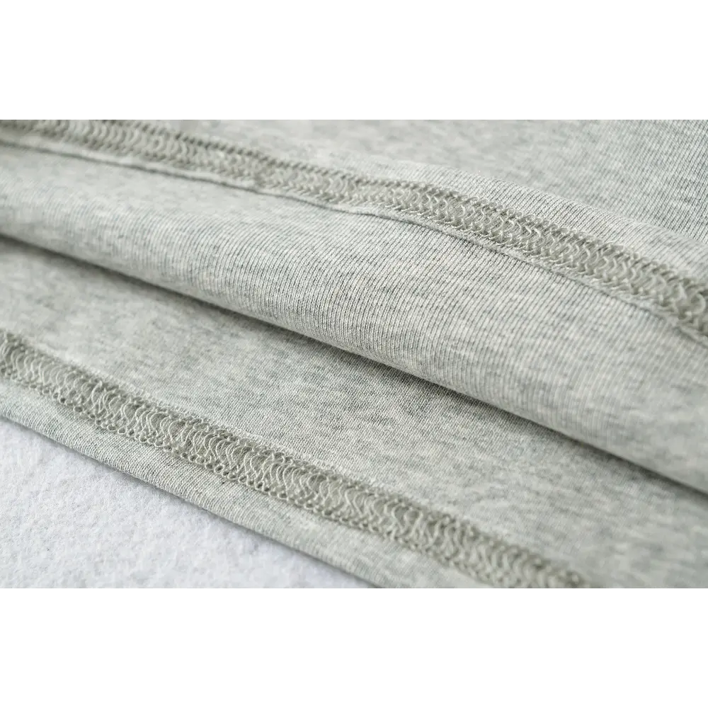 Close-up of the hem binding and double stitching on the gray camisole