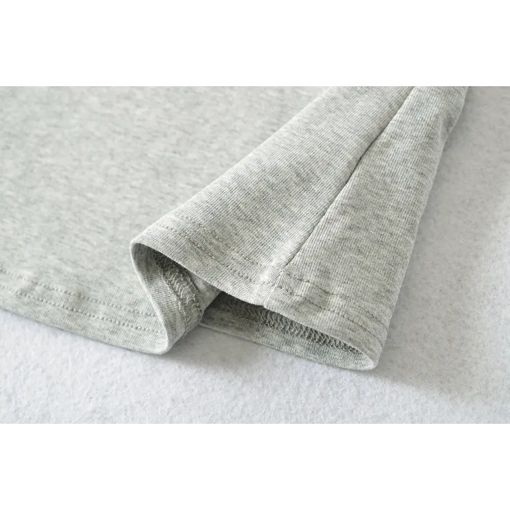 Close-up of the finished hem stitching on the gray and light blue camisole