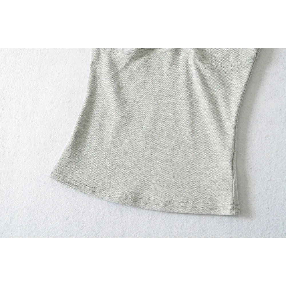 Close-up of the fabric texture and hem stitching on the gray camisole