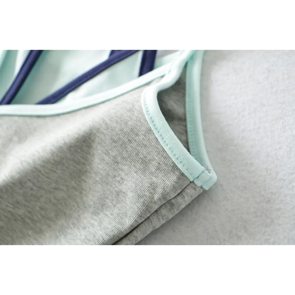 Close-up of the strap edge stitching on the gray and light blue camisole