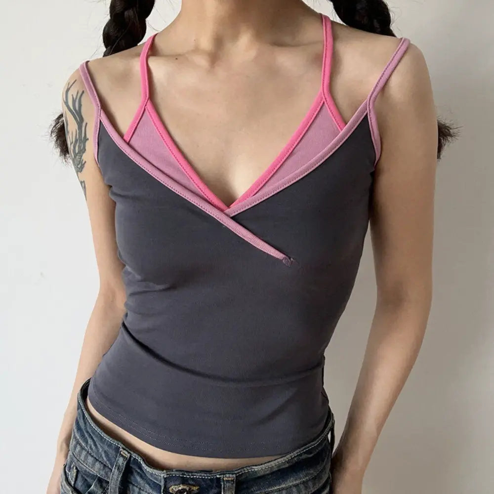 Lifestyle shot of model wearing the layered gray and pink V-neck camisole top