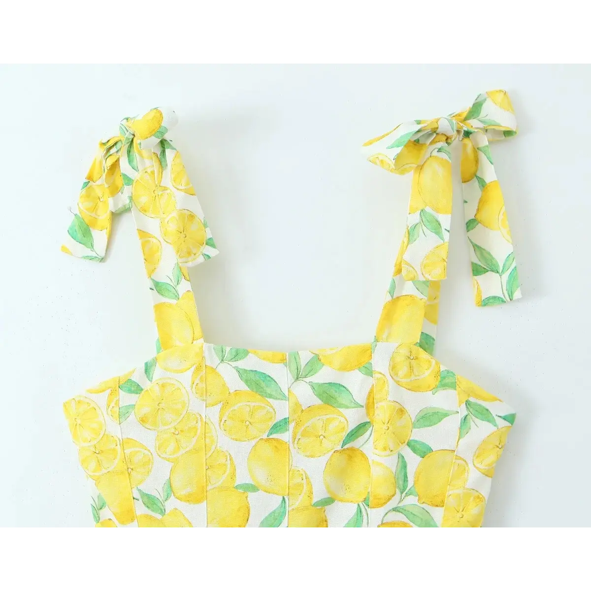 Full front view of the lemon print tie-strap dress, showing the square neckline and shoulder bows.
