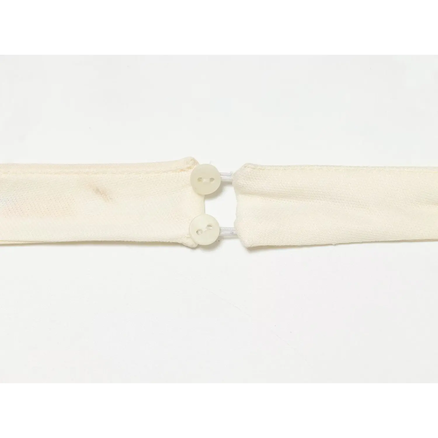 Detail shot of halter neck adjustable button closure
