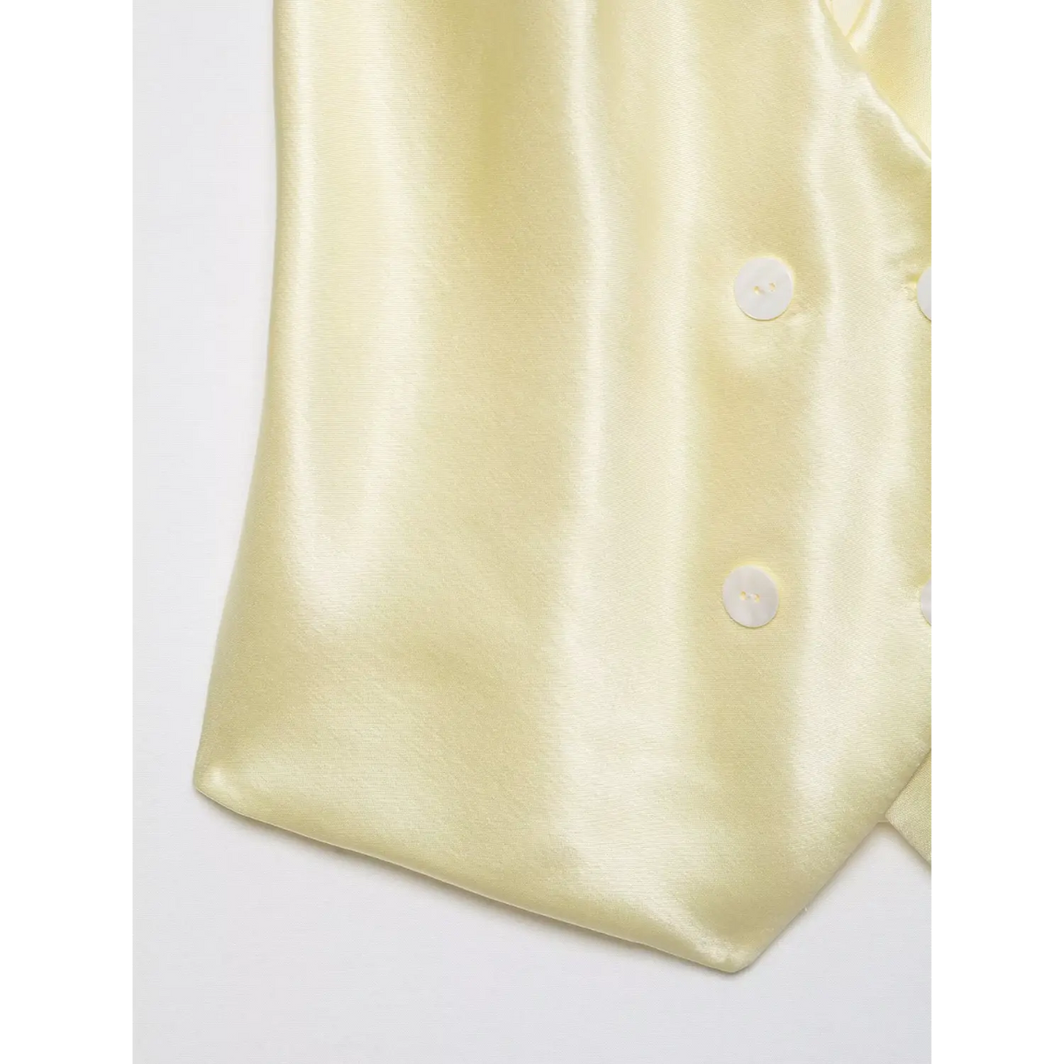 Close-up of pointed hem and buttons