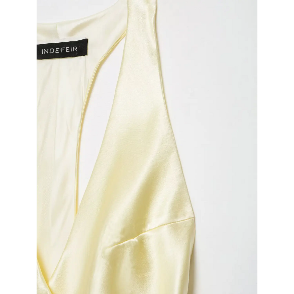 Close-up of shoulder strap and V neckline
