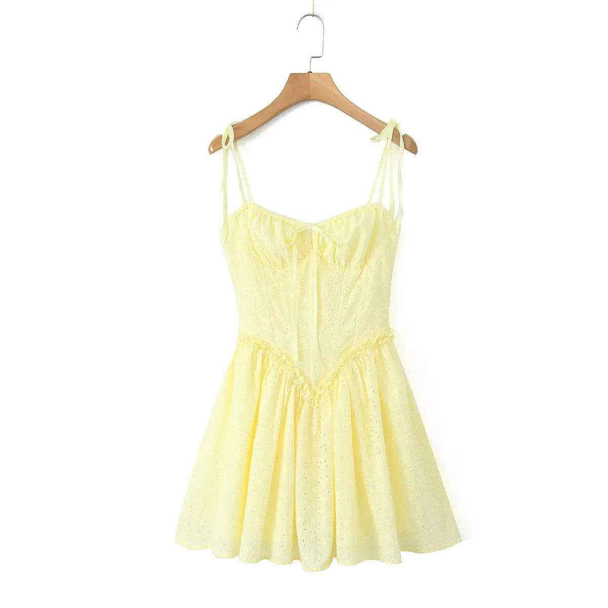 Full front flat lay of butter yellow eyelet mini dress, tie self-fabric straps, ruched bust, fitted waist and flared gathered skirt.