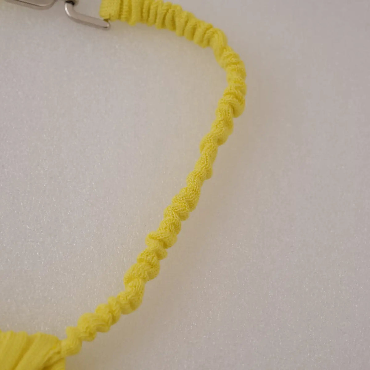 Close-up of smocked elastic neck strap