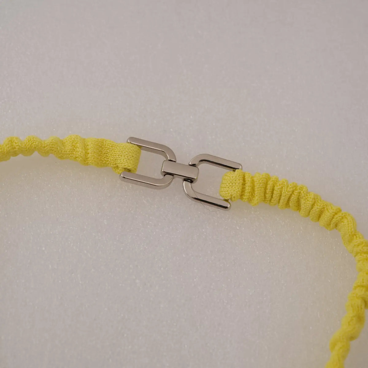 Close-up of silver metal clasp on neck strap