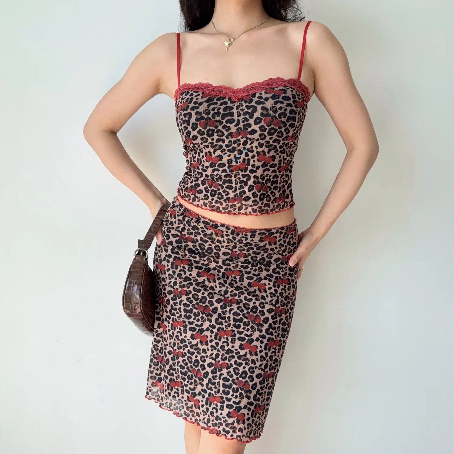 Front lifestyle shot on model of leopard cherry printed mesh matching set, lace scallop neck cami crop top, high waist midi skirt, casual summer coordinate